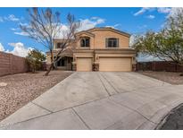 Charming two-story home boasts a spacious driveway, well-kept yard, and a two-car garage at 23000 W Kimberly Dr, Buckeye, AZ 85326