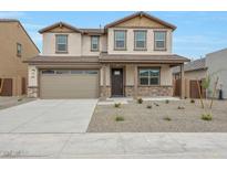 Charming two-story home featuring a neutral stucco exterior, a two-car garage, and a well-maintained front yard with minimal landscaping at 24216 W Agora Ln Ln, Buckeye, AZ 85326