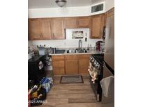 Bright kitchen features ample cabinetry and a double sink at 2503 E Southgate Ave, Phoenix, AZ 85040