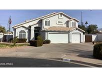 Two-story house with a large driveway and landscaped front yard at 3554 E Camino Cir, Mesa, AZ 85213