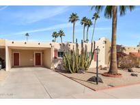 Desert landscape surrounds this charming single-level home with a covered carport at 7714 E Mariposa Dr, Scottsdale, AZ 85251