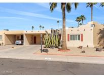 Front view of a single level home with carport and desert landscaping at 7714 E Mariposa Dr, Scottsdale, AZ 85251