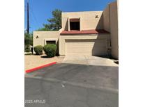 Tan two-story stucco home with red tile roof and attached garage at 8883 N 48Th Dr, Glendale, AZ 85302