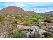 Expansive desert home with tile roof, surrounded by native vegetation, a golf course, and mountain views at 10040 E Happy Valley Rd # 300, Scottsdale, AZ 85255