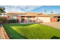 Charming one-story home with a spacious green lawn at 1028 E Emerald Ave, Mesa, AZ 85204