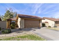 Cute single story home with a two-car garage and desert landscaping at 12218 S Shoshoni Dr, Phoenix, AZ 85044
