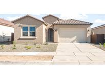 Single-story home with a tile roof, two-car garage, and low-maintenance front yard at 18169 E Bronco Dr, Queen Creek, AZ 85142
