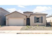 Charming single-story home with a two-car garage, desert landscaping, and a stylish front door at 18180 E Tiffany Dr, Queen Creek, AZ 85142