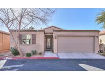 Inviting single-story home features a two car garage, desert landscaping, and a charming front entrance at 2565 E Southern Ave # 102, Mesa, AZ 85204