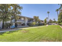 Mid-century modern apartment building with manicured lawn and palm trees at 5150 N 20Th St # 201, Phoenix, AZ 85016