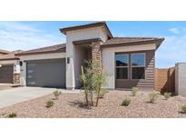 Charming single-story home with modern design elements and a well-maintained desert landscaped front yard at 564 E Aurora Dr, San Tan Valley, AZ 85140