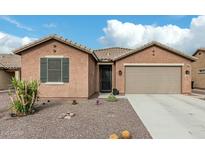 Charming single-story home featuring a tile roof, low maintenance desert landscaping, and a two car garage at 7564 W Darrel Rd, Laveen, AZ 85339