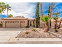 Charming single-story home with a desert landscape, palm trees, and a three-car garage at 8909 E Hercules Ct, Sun Lakes, AZ 85248