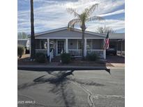 Charming single-story home with a covered front porch, well-maintained landscaping and covered parking at 11411 N 91St Ave # 225, Peoria, AZ 85345