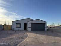 New construction home with gray garage door and landscaped front yard at 1238 S 14Th St, Phoenix, AZ 85034