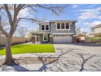 Charming two-story home with well-manicured lawn and inviting curb appeal, featuring a two car garage and a covered entryway at 1578 S Sabino Ct, Gilbert, AZ 85296