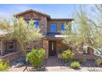 Charming two-story home with stone accents, desert landscaping, and inviting front entrance at 17763 N 93Rd Way, Scottsdale, AZ 85255