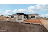 Stunning home featuring a stone facade, modern pergola, and desert landscaping at 2809 N 82Nd Pl, Mesa, AZ 85207