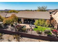 Inviting backyard with desert landscaping, small pool, and patio seating area at 41515 N Laurel Valley Way, Anthem, AZ 85086