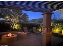Inviting outdoor patio with fireplace, pergola, and mountain views for relaxing evenings at 41532 N Clear Crossing Rd, Anthem, AZ 85086