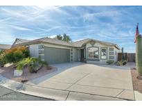 Single-story home with a two-car garage and desert landscaping at 8957 E Rainier Dr, Gold Canyon, AZ 85118