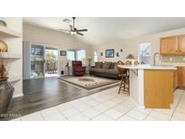 Open living space with hardwood floors, patio access, and a kitchen island at 8957 E Rainier Dr, Gold Canyon, AZ 85118