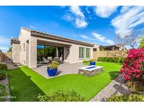 Spacious backyard with fire pit, patio, and artificial turf at 2049 N 88Th St, Mesa, AZ 85207