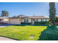 Ranch style home with a two-car garage and well-manicured lawn at 21 W Del Rio Dr, Tempe, AZ 85282