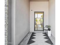 Stylish front entry with modern door and a welcoming sitting area at 23491 N 125Th Pl, Scottsdale, AZ 85255