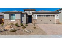 This home boasts desert landscaping and a two-car garage at 25948 W Sands Dr, Buckeye, AZ 85396