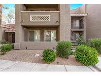 Exterior view of condo building showcasing landscaping and private entrance at 2929 W Yorkshire Dr # 1118, Phoenix, AZ 85027