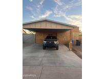 Newly constructed home with carport and front yard at 3133 W Polk St, Phoenix, AZ 85009