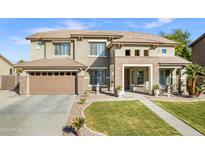 Stunning two-story home with a tile roof, manicured lawn, and a spacious two-car garage at 476 E Atlantic Dr, Casa Grande, AZ 85122