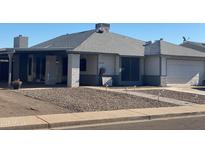 Single-story home with attached garage and landscaped front yard at 5312 W Columbine Dr, Glendale, AZ 85304