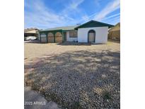 Ranch style home with green roof and gravel landscaping at 6039 N 73Rd Ave, Glendale, AZ 85303