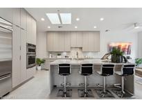 Modern kitchen featuring sleek cabinetry, a spacious island, and stainless steel appliances at 7705 E Doubletree Ranch Rd # 56, Scottsdale, AZ 85258