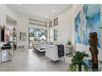 Bright living room with high ceilings, modern finishes, and large windows providing ample natural light at 7705 E Doubletree Ranch Rd # 56, Scottsdale, AZ 85258