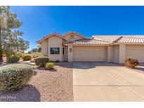 Tan stucco home with a two-car garage and desert landscaping at 7928 E Pueblo Ave # 62, Mesa, AZ 85208