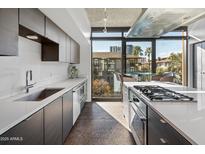 Modern kitchen with stainless steel appliances and ample cabinet space at 100 W Portland St # 401, Phoenix, AZ 85003