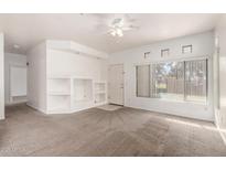 Open concept living room with neutral carpet, white walls, and a view to the entryway at 1351 N Pleasant Dr # 1102, Chandler, AZ 85225