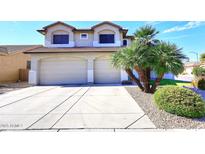Two-story house with a two car garage and desert landscaping at 19520 N 65Th Ave, Glendale, AZ 85308