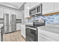 Modern kitchen featuring stainless steel appliances and a gray quartz island at 1959 E Hampton Ln # 102, Gilbert, AZ 85295