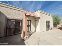 Front view of stucco house with gated entry and courtyard at 209 E Loma Linda Blvd # 1, Avondale, AZ 85323