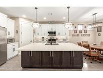 Modern kitchen with a large island, stainless steel appliances, pendant lights, and white cabinetry at 2306 N Floyd Dr, Mesa, AZ 85215