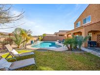 Relaxing backyard oasis with a pool, lawn area, and patio at 2404 E Gillcrest Rd, Gilbert, AZ 85298