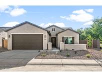 Charming single-story home with a well-maintained front yard and a two-car garage at 3218 N Lafayette Dr, Florence, AZ 85132