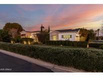 Brick house with a landscaped yard at dusk at 5430 E Calle Redonda --, Phoenix, AZ 85018