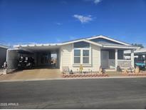 Cute manufactured home with carport and landscaped yard at 650 N Hawes Rd # 2713, Mesa, AZ 85207