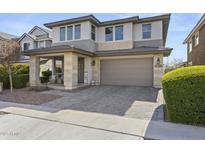 Charming two-story home with neutral tones, landscaped front yard, and inviting covered porch area at 14369 W Wethersfield Rd, Surprise, AZ 85379