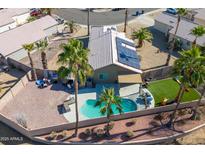 Aerial view of a private backyard featuring a pool, patio and artificial turf at 16934 N 158Th Ave, Surprise, AZ 85374